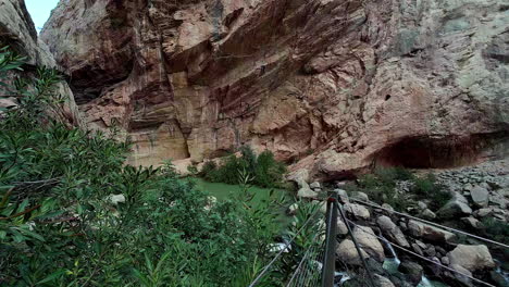 Slowmotion-panning-shot-of-Caminito-del-Rey-between-the-steep-mountains-in-summer-time