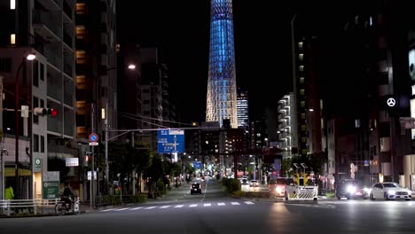 urban night scene with traffic and a lit tower