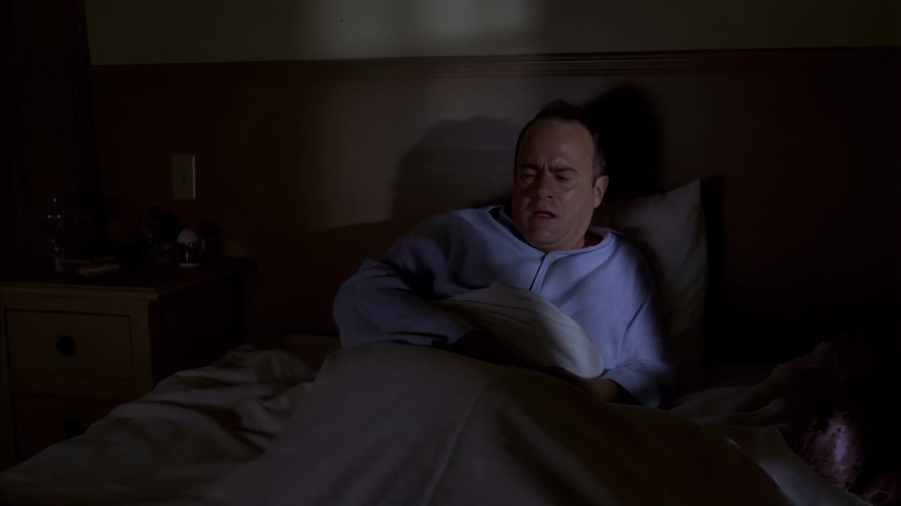 Man Waking Up Distressed in Bed at Night