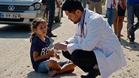 doctor providing aid to a child on the street