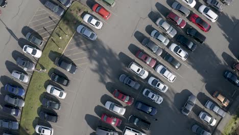 aerial view of a grey car passing on a parking lot - aerial shot