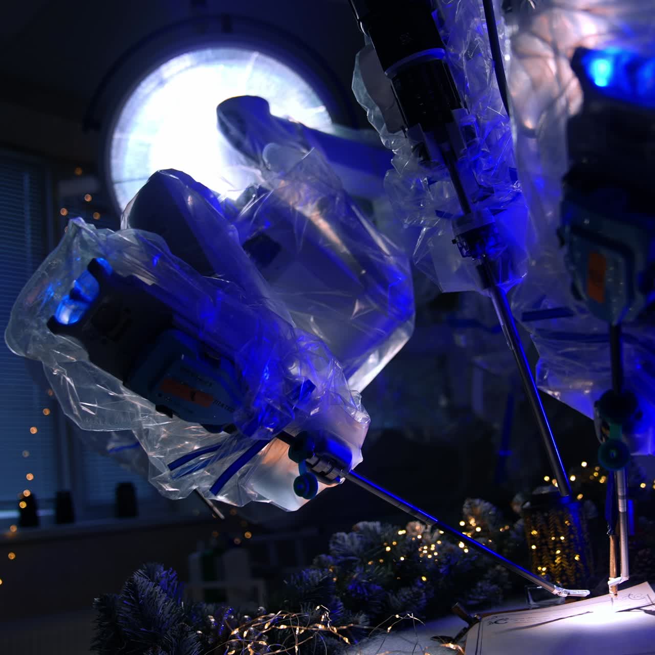 Writing Christmas letter using the technological advanced equipment in dark surgery room. Da Vinci robot work demonstration