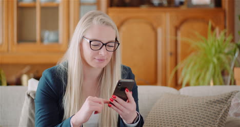 Businesswoman-Using-Mobile-Phone-On-Sofa-5