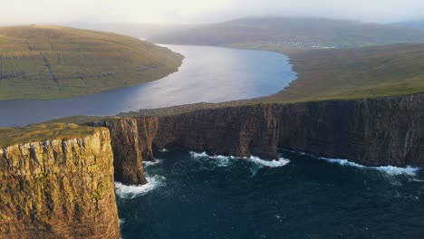 medium to far range drone footage of the leitisvatn lake, aka the floating lake, on the vagar island in the faroe islands