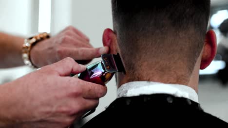 barber using buzzer on client's hairline