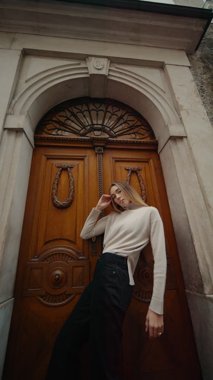 Woman Posing in Front of Ornate Wooden Door