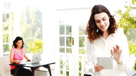 Waitress-using-digital-tablet-in-restaurant