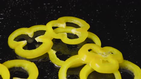 yellow bell pepper rings on a dark surface