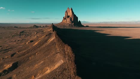 wide pull back cinematic drone footage of ship rock, new mexico