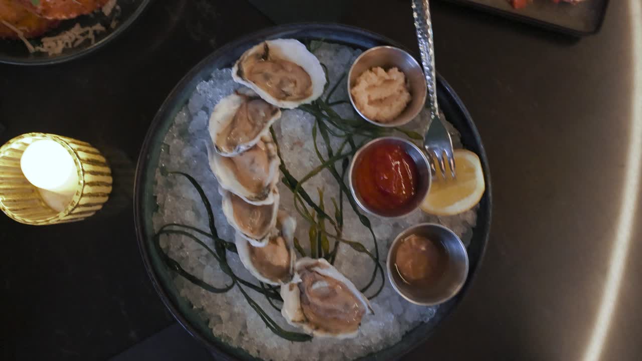 Cinematic top-down pan over a table full of assorted appetizers