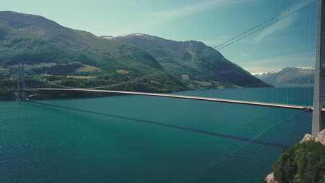 elevating drone shot of a suspension bridge on a sunny day