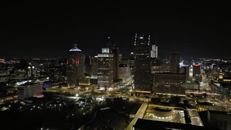aerial view approaching the illuminated detroit skyline, night in michigan, usa