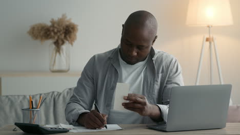 man paying bills at home