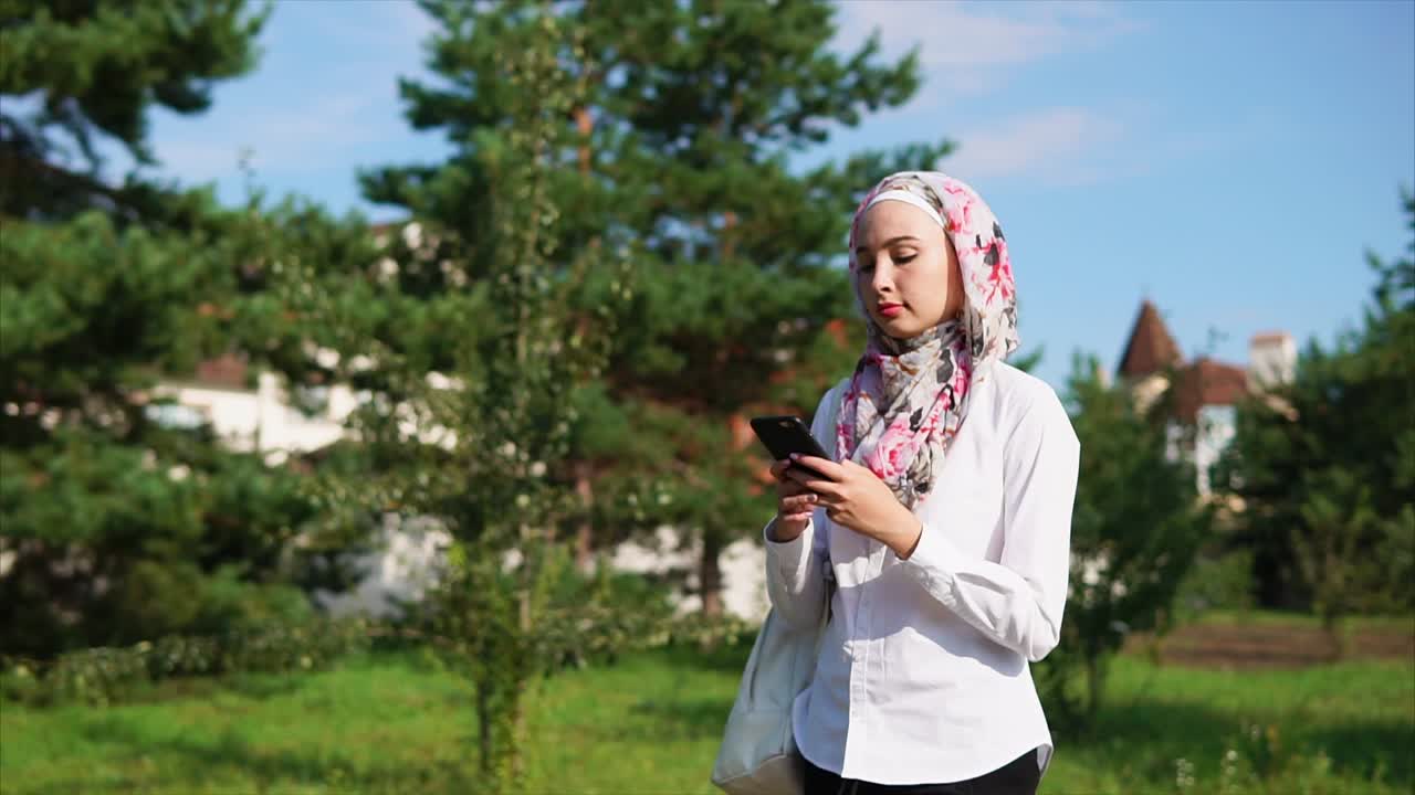 Muslim Woman Using Phone Outdoors
