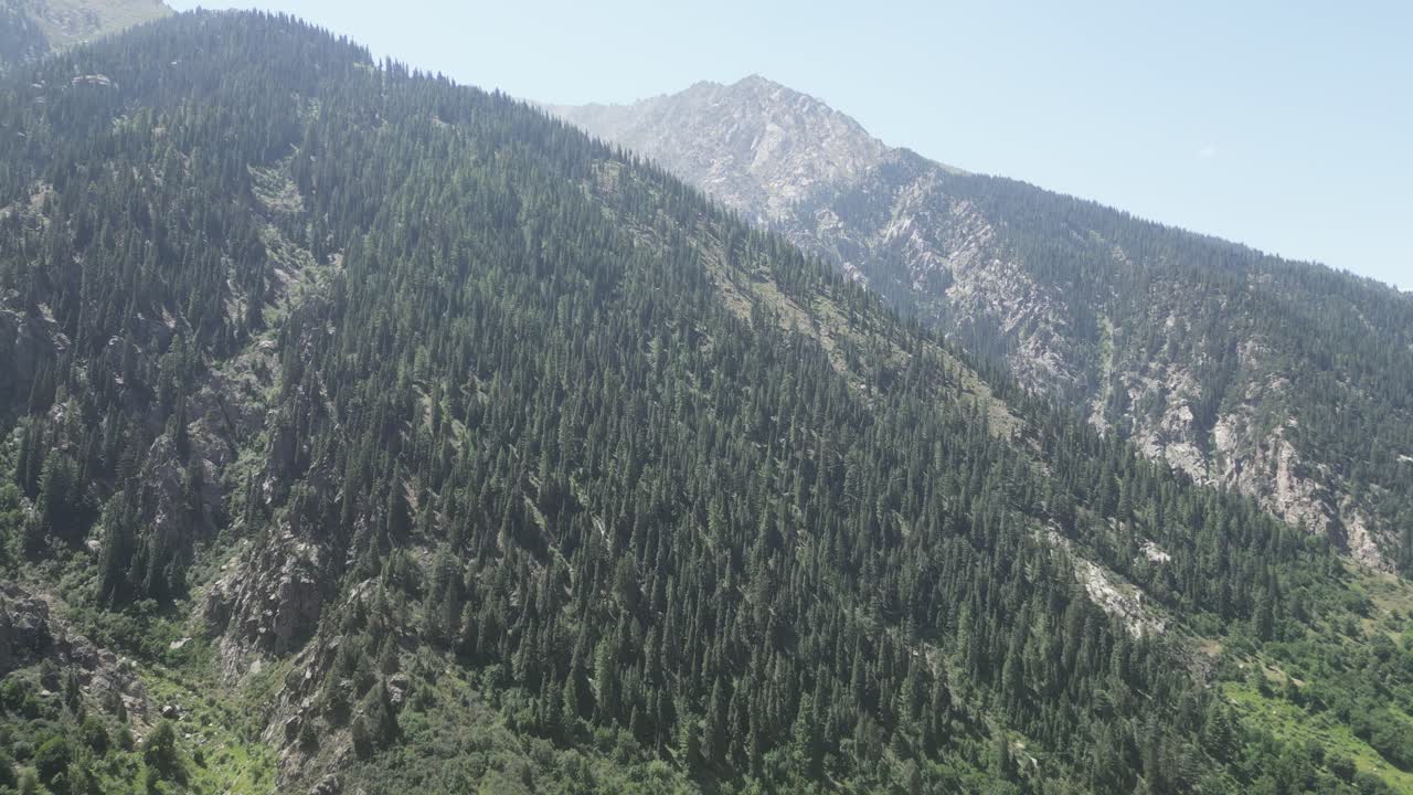Aerial view approaching large mountains in east Afghanistan, sunny day