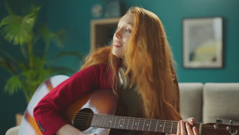 woman sitting with a guitar on her lap