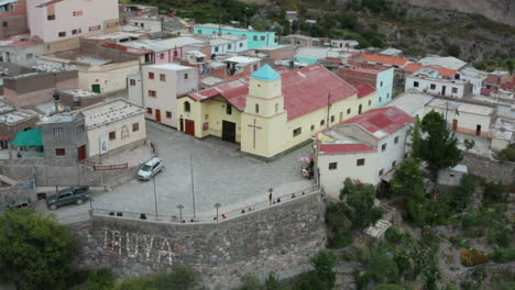 Aerial---church-of-Iruya-town,-Andes-mountains,-Argentina,-wide-backward