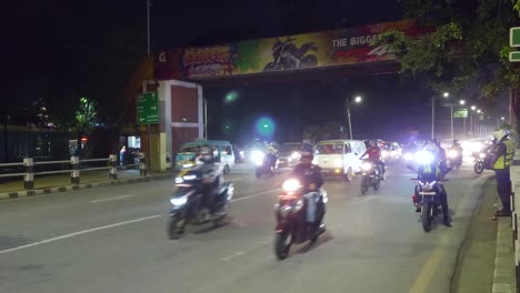 cars and motorcycles driving on the highway at night in katmandu, nepal. - static shot