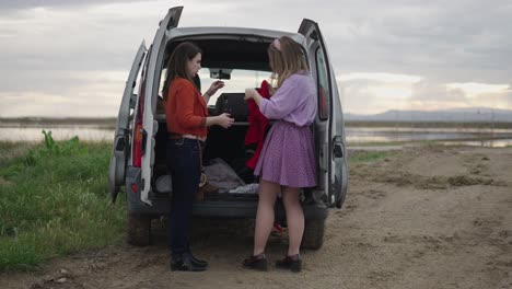 women loading a van for a road trip