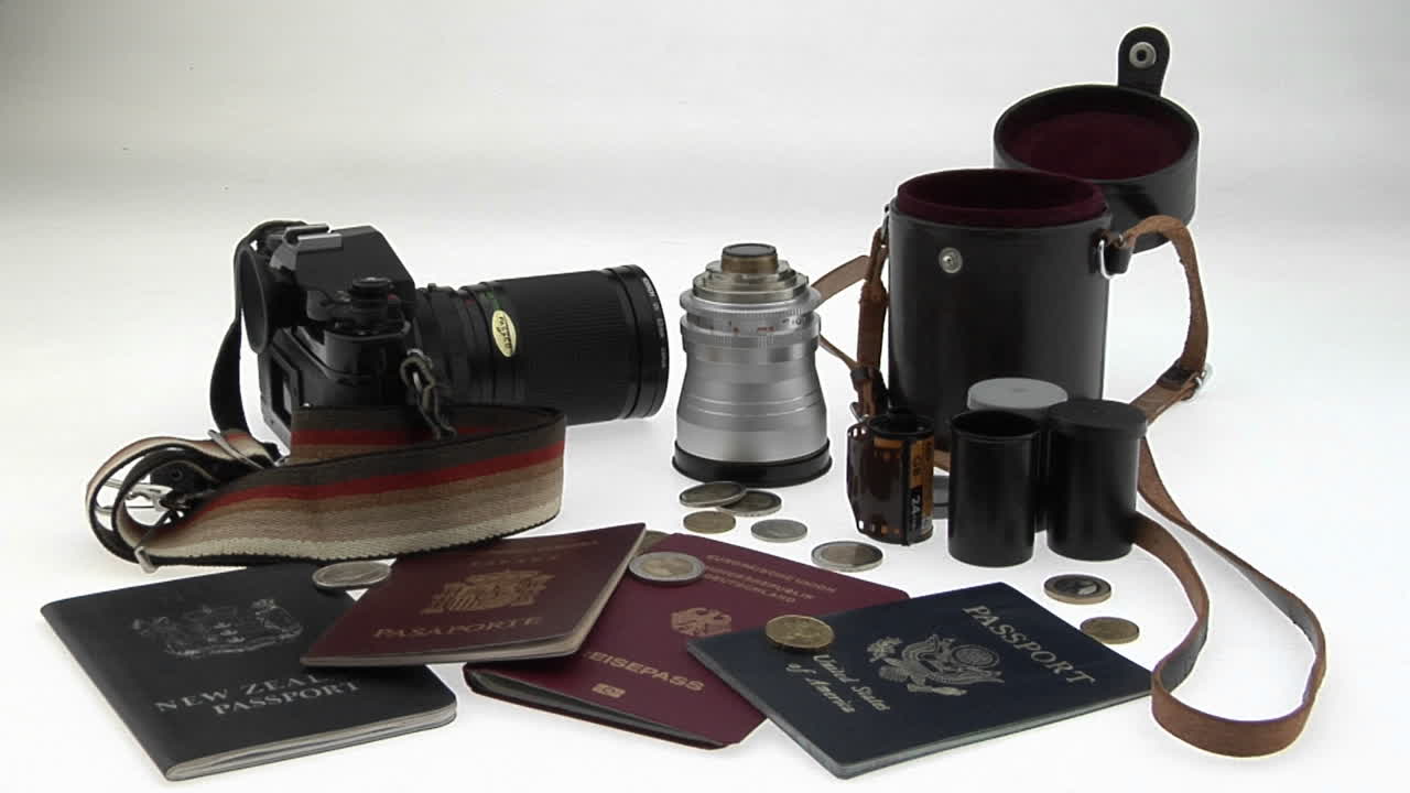 Travel and photography equipment sit on a white surface