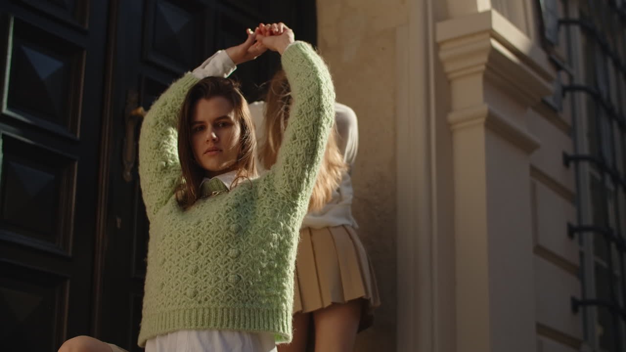 Two Women Posing in Stylish Outfits