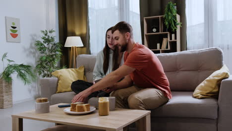 couple sitting on the sofa at home