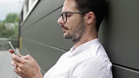 businessman typing on mobile phone