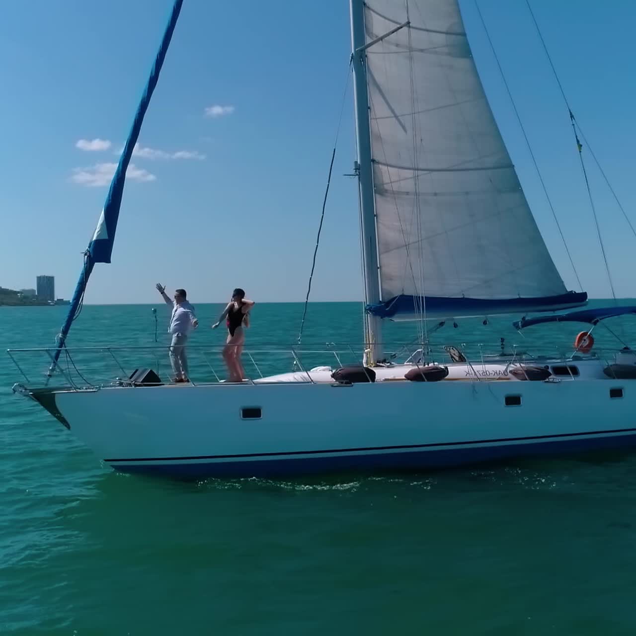 Big yacht riding on the sea. Young group of people have a rest on a yacht