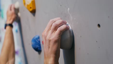 person rock climbing on a climbing wall