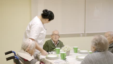 old man smiling and talking to the cook