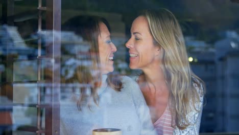 Woman-having-coffee-while-her-partner-hugging-from-back-4k