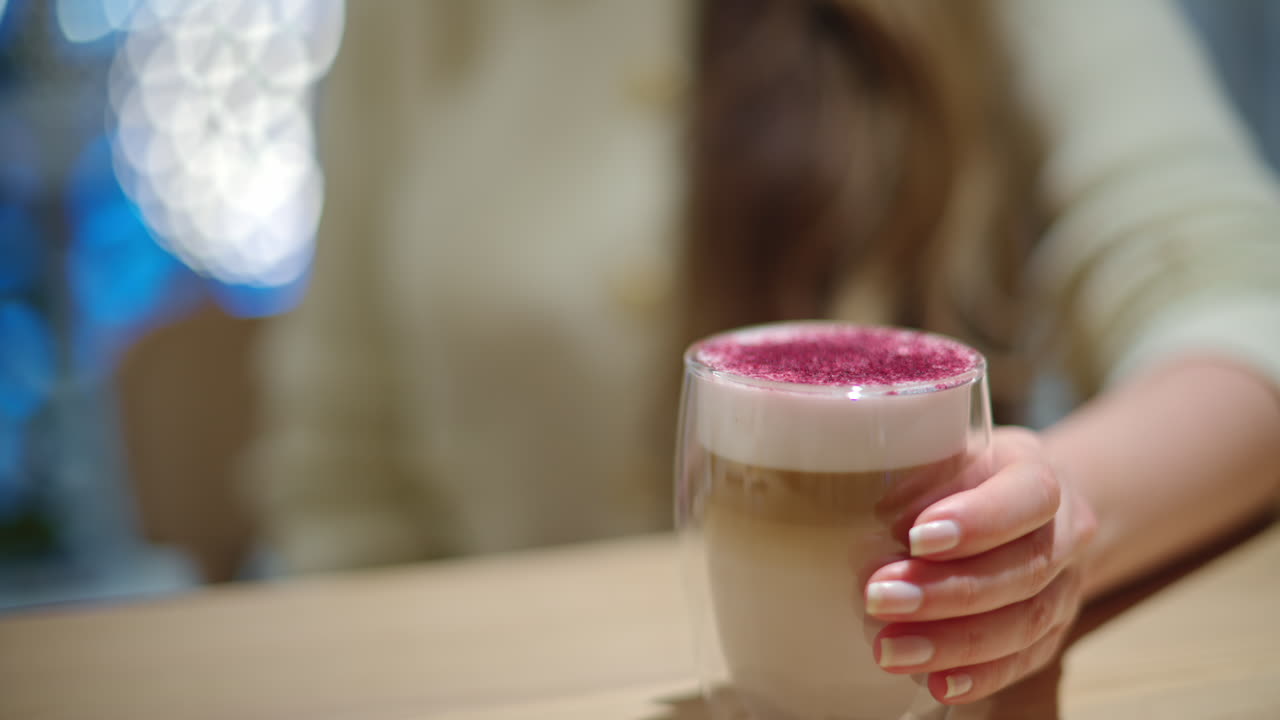 Woman drinking lavender raf coffee at a restaurant