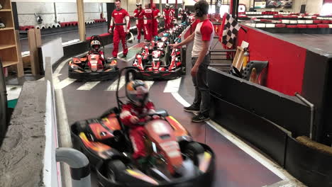 kids departing for a race with karts on the circuit.