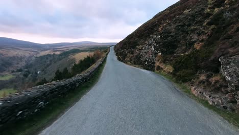 Point-of-view,-POV-windshield-shot,-stabilised,-smooth-view-as-driving-on-a-rural,-asphalt-road