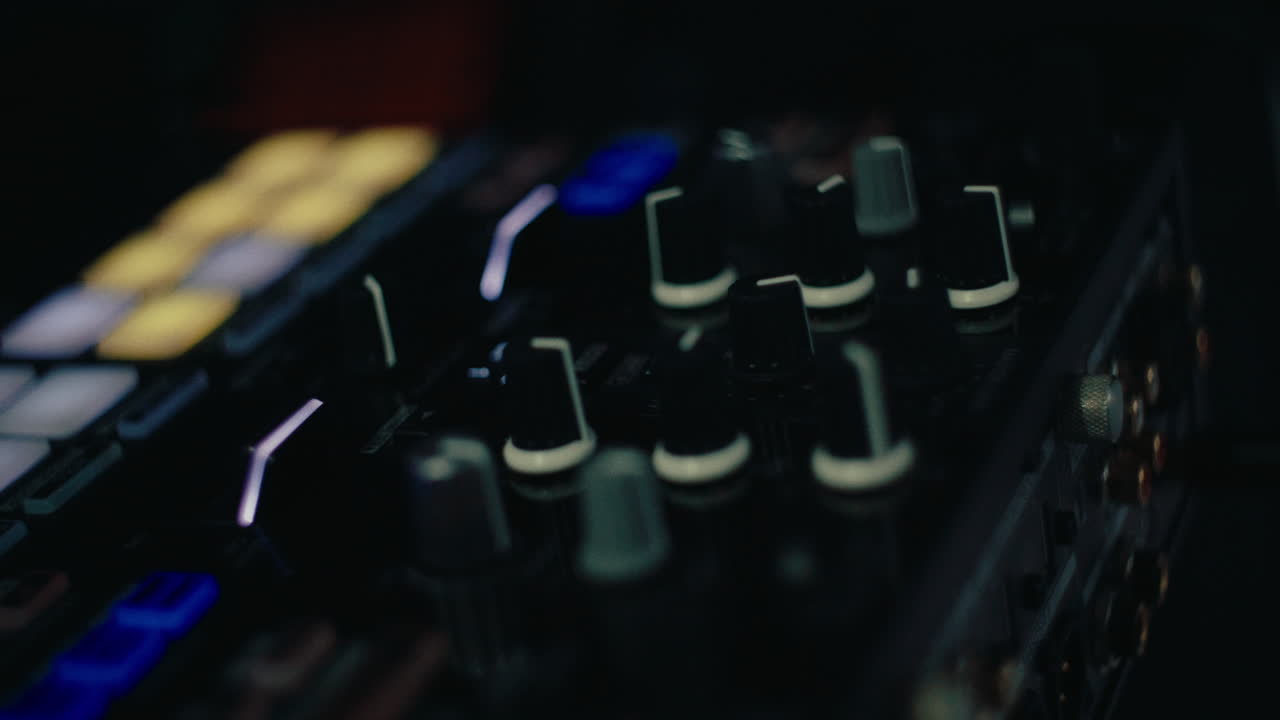 close up of mixer control with falling led light using by dj for play music set playlist at party