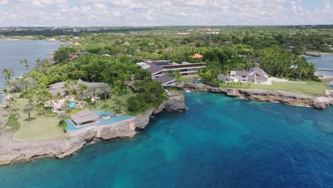 oceanfront luxury villas with private pool on cliffs, casa de campo, la romana, caribbean coast, dominican republic. aerial drone orbiting