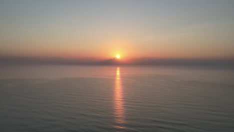 Aerial-Drone-Shot-Over-the-Gulf-of-Thailand-with-a-Beautiful-Sunrise-with-Orange-Glowing-Reflection-on-the-Water