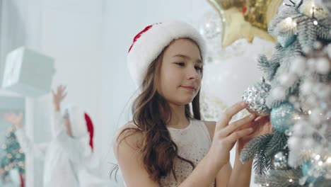 concentrated sister delighting decoration. relaxed boy playing with present box