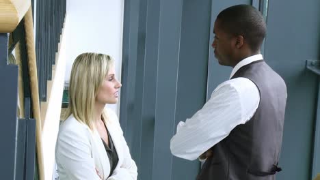Blonde-businesswoman-and-AfroAmerican-businessman-talking-in-workplace-footage