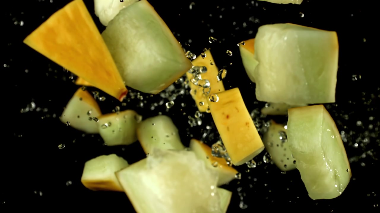 Slow Motion of Fresh Melon Pieces Splashing with Water