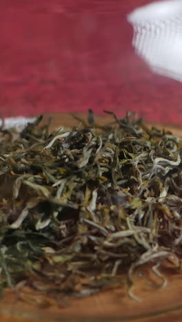close-up of loose leaf green tea in a glass jar