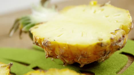 Halved-pineapple-on-chopping-board