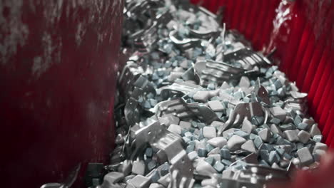 metal components for cars are rinsed and cleaned after they come from an automated production line in the factory