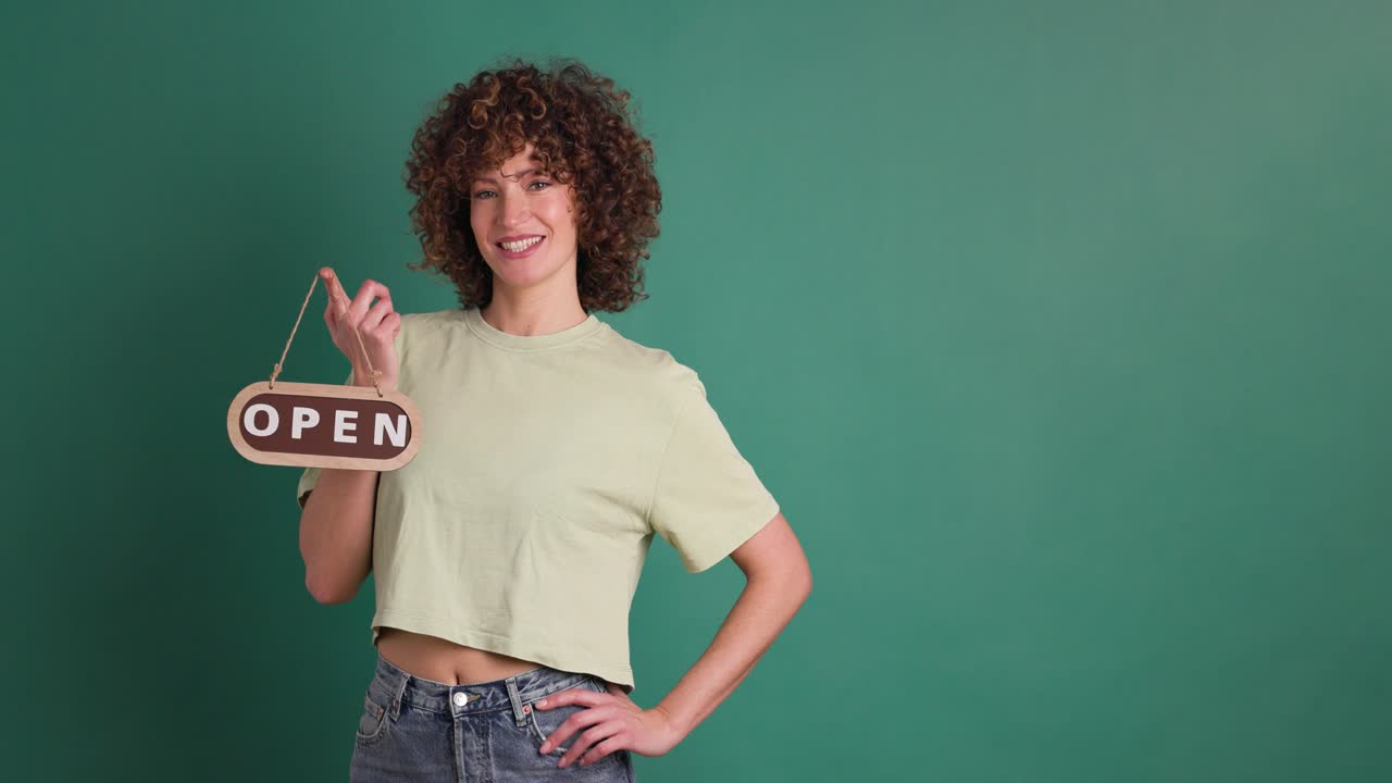 woman with open sign on a green background