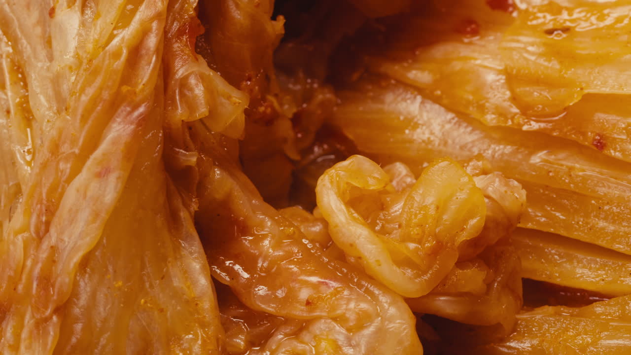 Close-up of texture fermented spicy cabbage kimchi with in can. Preservation of vegetables in glass jars. Fermentation preserved kimchi cabbage with spices macro. Asian cuisine.