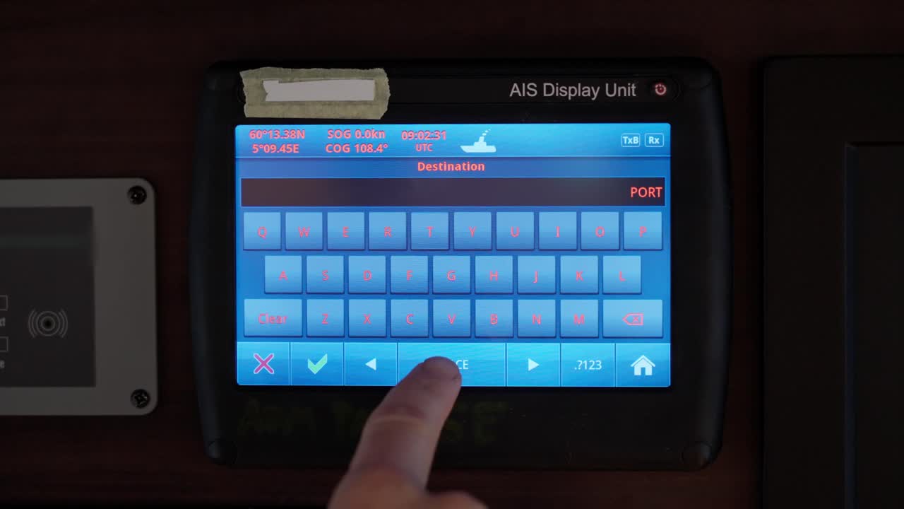 Captain entering Port Said as destination into ship's AIS navigation system