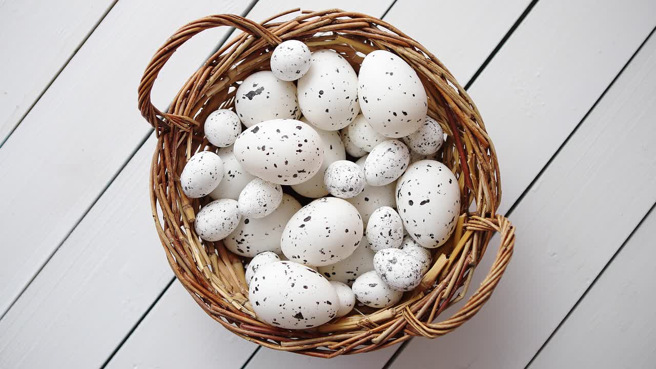Basket of white dotted Easter eggs in brown wicker basket