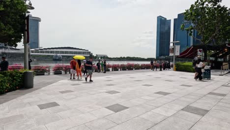 pedestrians enjoying a lively city riverside walk