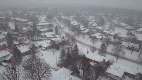 winter aerial view of snow covered houses in a residential community