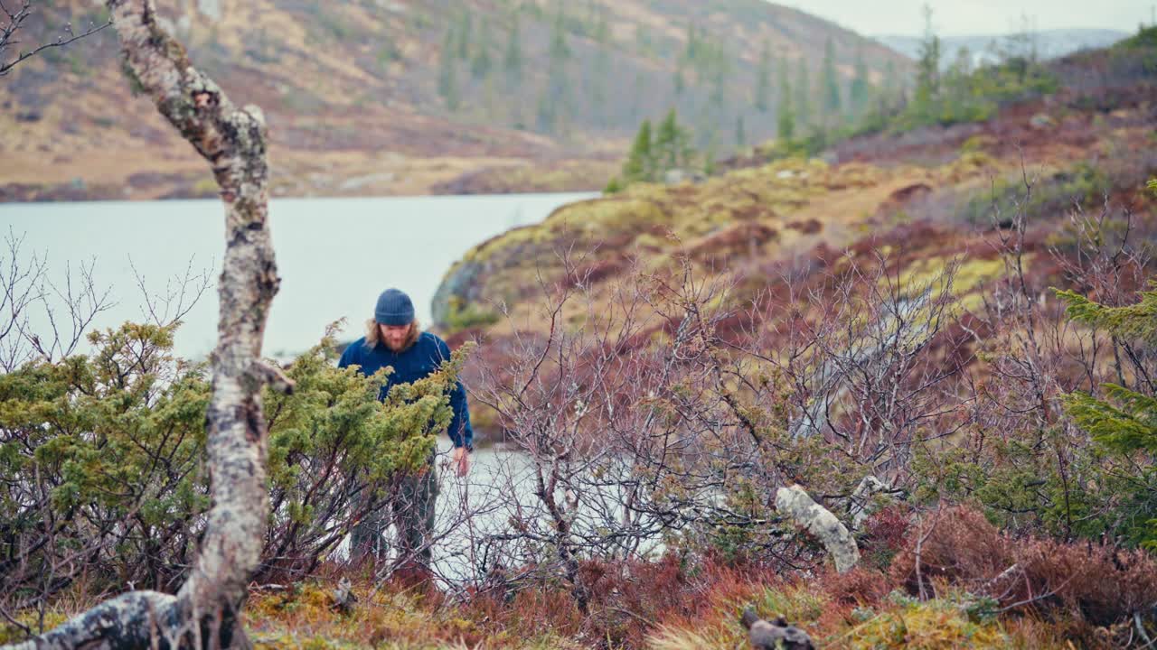 Man Walking With A Kettle During Camping In Åfjord, Norway - Wide Shot